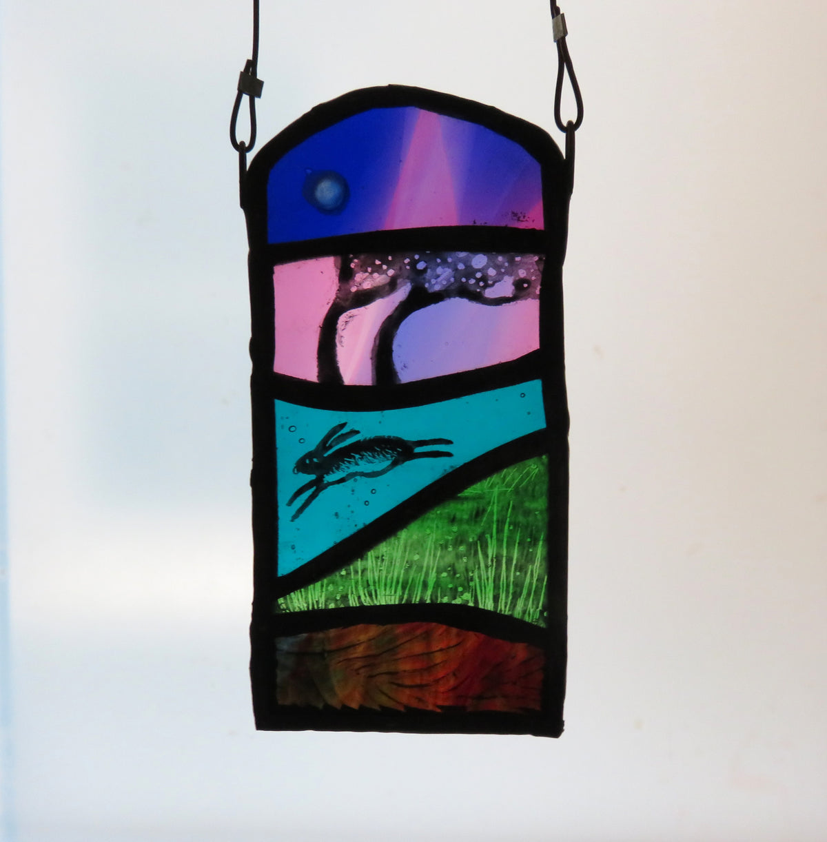 Running Hare & Moon - stained glass panel by Debra Eden
