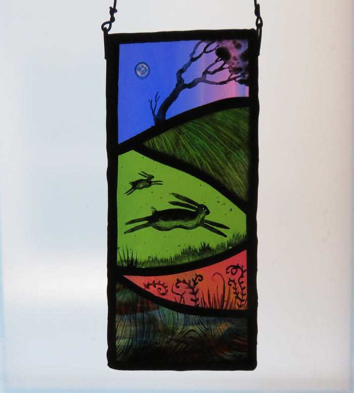 Running Hares - stained glass panel by Debra Eden