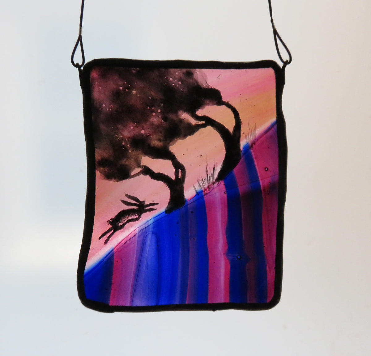 Tree Slope & Hare - stained glass panel by Debra Eden