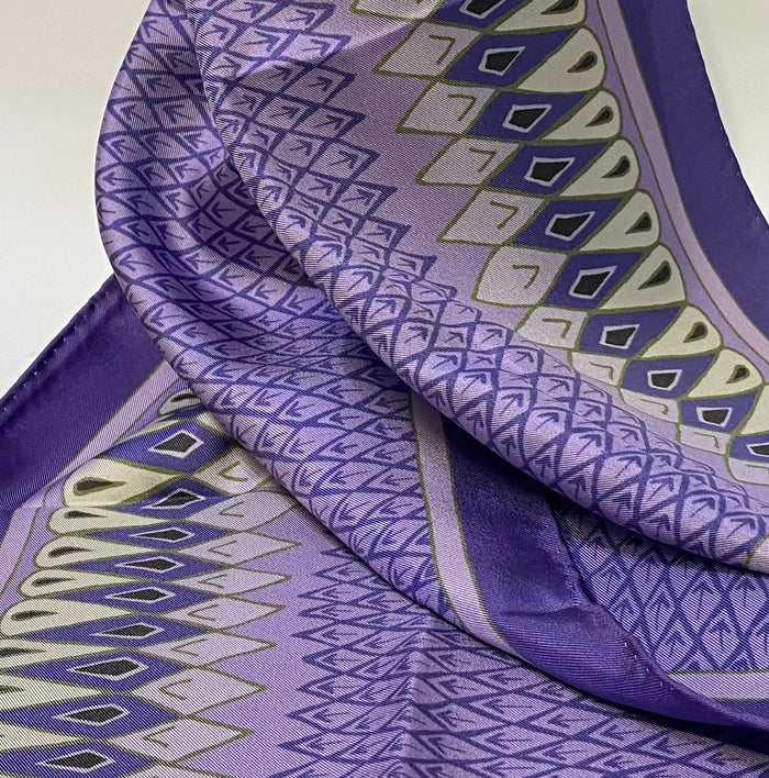 Long, luxurious 100% silk scarf printed with a feather inspired design by Faye Stevens.