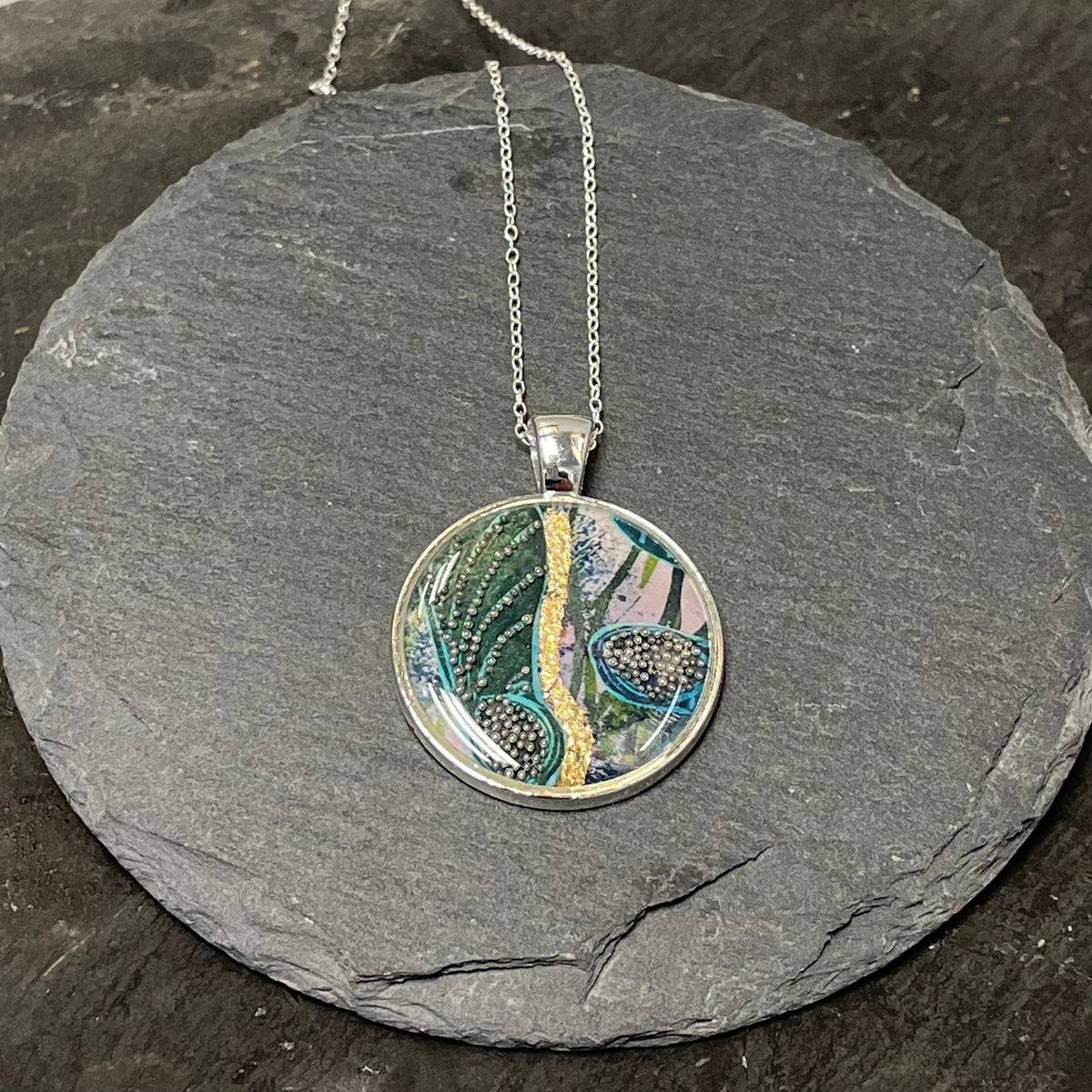 Small turquoise and gold leaf circular pendant by NimaNoma