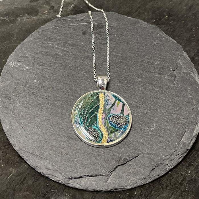 Small turquoise and gold leaf circular pendant by NimaNoma