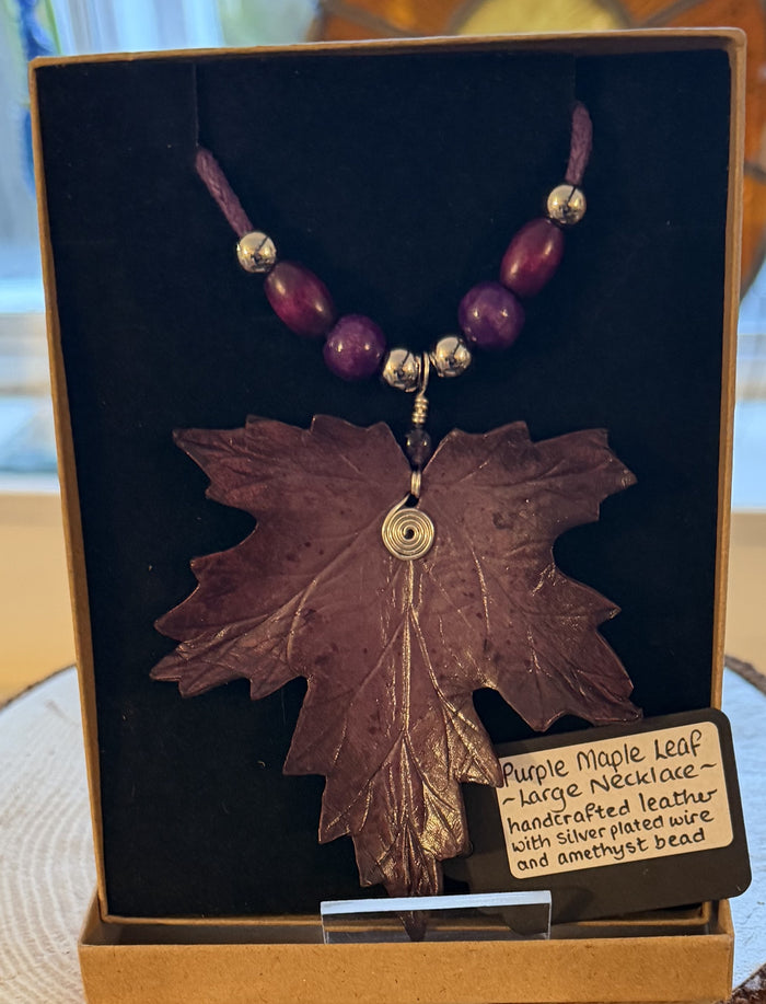 Purple maple leaf necklace with beads in a display box