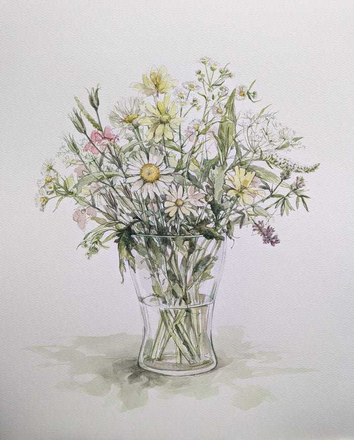 Glass vase with a bouquet of wildflowers on a light background