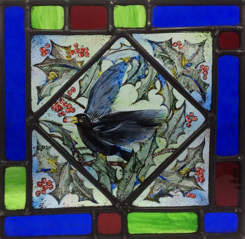 Blackbird in Holly, stained glass by Bryan Smith