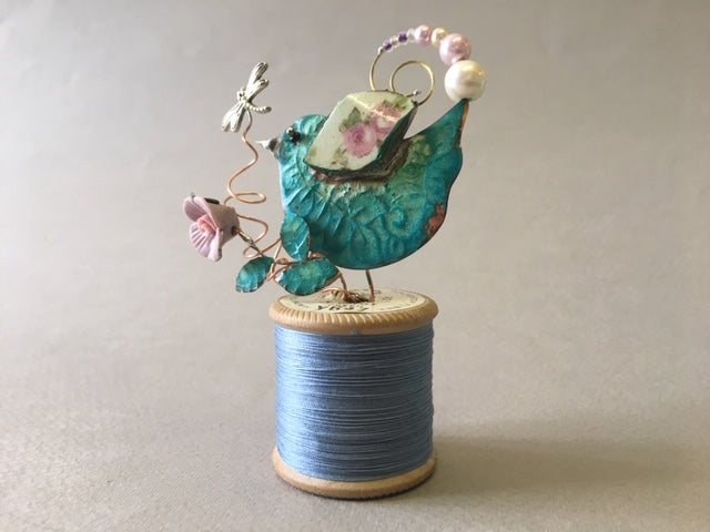 Small Bird on Blue Cotton Reel by Linda Lovatt